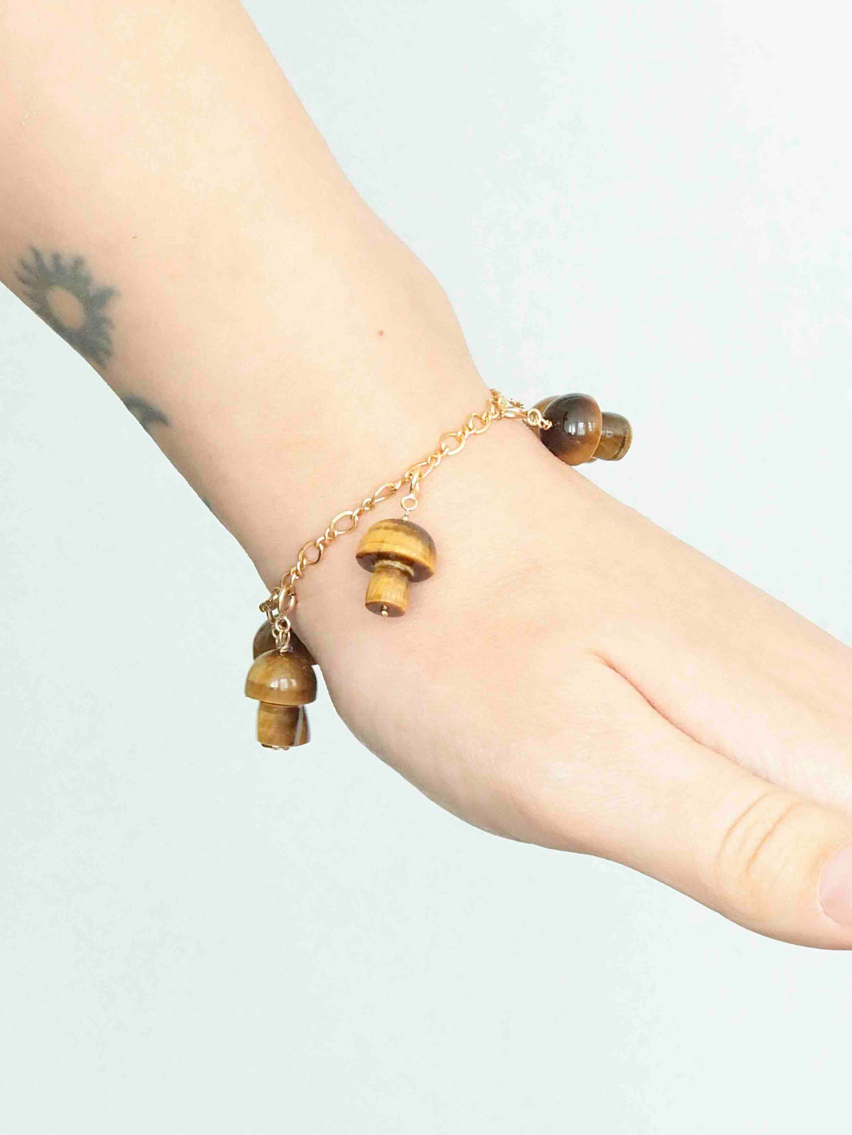 Bracelet à charms Gold-filled 14K avec charms champignon en Œil-de-Tigre portés au poignet — SOLYA