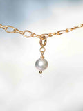Gros plan sur le Charm Perle grise Gold-filled 14K — Pierre de circulation des énergies SOLYA