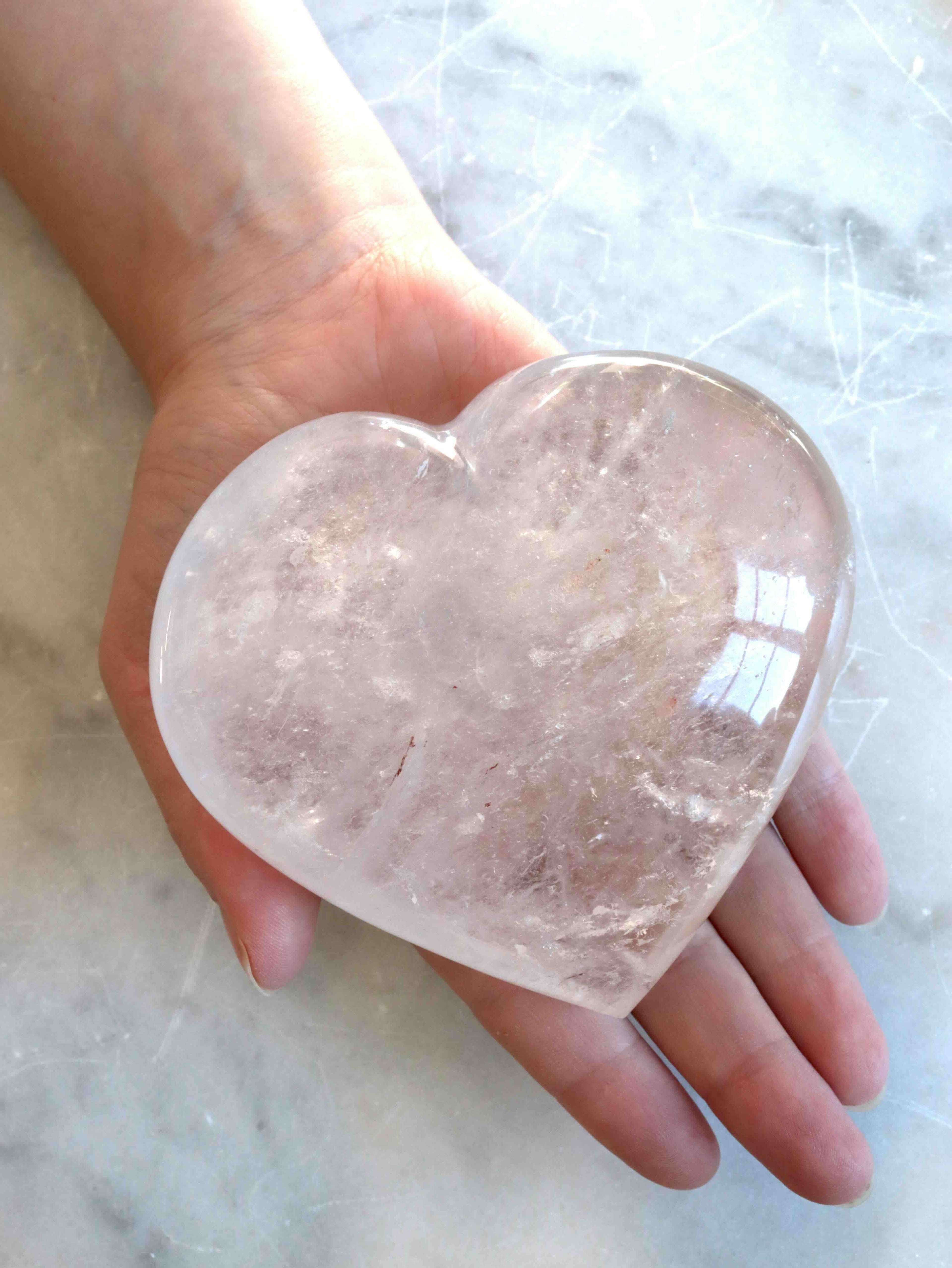 Cœur en Cristal de Roche tenu en main – Pierre de clarté – Boutique SOLYA Belgique