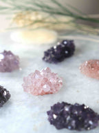 Gros plan sur des mini fleurs d'améthyste, pointes de quartz violet déployées comme des pétales, pierres de lithothérapie